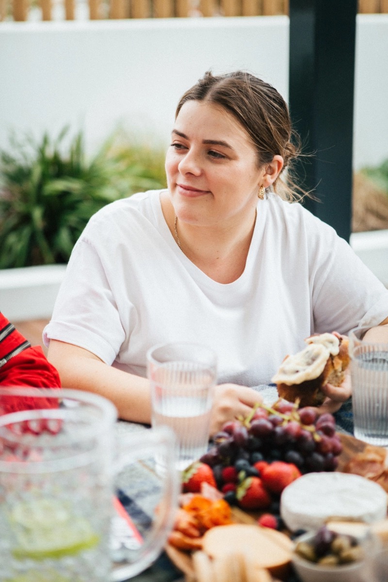 A guest at the table with a shared spread of food at a recent night